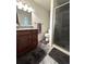 Updated bathroom with granite countertop, modern fixtures, and a glass-enclosed shower at 13126 W Warren Cir, Lakewood, CO 80228