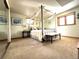 Bright bedroom featuring a four-poster bed with sheer curtains and hardwood window frames at 13126 W Warren Cir, Lakewood, CO 80228