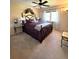 Charming bedroom with a decorative iron bed frame, floral accents, and bright natural light at 13126 W Warren Cir, Lakewood, CO 80228