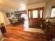 Spacious foyer with wood floors, wooden front door, views to formal dining room at 13126 W Warren Cir, Lakewood, CO 80228