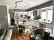 Open kitchen featuring an island, granite countertops, stainless steel appliances, white cabinets and an eating nook at 13126 W Warren Cir, Lakewood, CO 80228