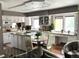 Open kitchen featuring an island, granite countertops, stainless steel appliances, white cabinets and an eating nook at 13126 W Warren Cir, Lakewood, CO 80228