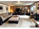 Cozy living room features a large sectional sofa, wood paneled walls, and a media center at 13126 W Warren Cir, Lakewood, CO 80228