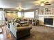 Cozy living room featuring a fireplace, neutral carpet, ceiling fans, and comfortable seating for Gathering and guests at 13126 W Warren Cir, Lakewood, CO 80228