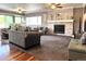 Bright living room featuring a fireplace, neutral carpet, ceiling fans, and comfortable seating for Gathering and guests at 13126 W Warren Cir, Lakewood, CO 80228