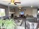 Bright living room featuring a fireplace, neutral carpet, ceiling fans, and comfortable seating for Gathering and guests at 13126 W Warren Cir, Lakewood, CO 80228