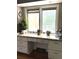 Bright work space under a window with beautiful granite countertops and custom white cabinets for plenty of storage at 13126 W Warren Cir, Lakewood, CO 80228