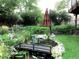 Backyard pond featuring a small bridge and vibrant foliage at 13126 W Warren Cir, Lakewood, CO 80228