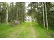 The wooded property is easily accessible with a path through the trees at 29055 S Sunset Trl, Conifer, CO 80433