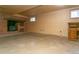 Basement rec room featuring wood-burning brick fireplace and hearth, and concrete floors at 29055 S Sunset Trl, Conifer, CO 80433