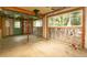 Unfinished basement area with exposed beams, windows, concrete floor, and a green door at 29055 S Sunset Trl, Conifer, CO 80433