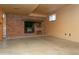 Basement rec room featuring wood-burning brick fireplace and hearth, and concrete floors at 29055 S Sunset Trl, Conifer, CO 80433