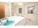 Vintage bathroom with double sinks, shower and tub combo, toilet, and patterned wallpaper at 29055 S Sunset Trl, Conifer, CO 80433