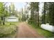 Exterior view of the driveway leading to the house and detached garage at 29055 S Sunset Trl, Conifer, CO 80433