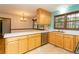 Bright kitchen featuring stainless steel appliances, wood cabinets, and island at 29055 S Sunset Trl, Conifer, CO 80433