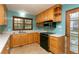 Cozy kitchen with stainless steel appliances, wood cabinets, and a tile backsplash at 29055 S Sunset Trl, Conifer, CO 80433