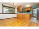 Open kitchen with wooden floors and a breakfast bar at 29055 S Sunset Trl, Conifer, CO 80433