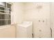 Small laundry room with floral wallpaper, linoleum flooring, wire shelving, and a front loading washing machine at 29055 S Sunset Trl, Conifer, CO 80433