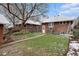 Brick home exterior with a grassy backyard and sidewalk at 3159 36Th Ave, Denver, CO 80211