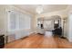 Bright living room featuring hardwood floors, large windows with sheer curtains, and an elegant chandelier at 3159 36Th Ave, Denver, CO 80211