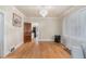 Spacious living room with hardwood floors, arched doorways, elegant chandelier, and views of kitchen at 3159 36Th Ave, Denver, CO 80211