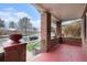 Inviting covered front porch with brick columns, a red painted floor, and views of the street at 3159 36Th Ave, Denver, CO 80211