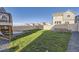 Expansive green backyard with a full lawn, wood fence, and stairs leading to the upper deck at 926 W Beverly St, Elizabeth, CO 80107