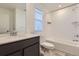Well-lit bathroom with a single sink, tiled shower over tub, and modern fixtures at 926 W Beverly St, Elizabeth, CO 80107