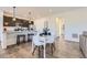 Bright dining area featuring modern table with white chairs and wood-style flooring at 926 W Beverly St, Elizabeth, CO 80107
