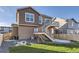 Exterior view of the home features a well-maintained backyard with a private deck and lush lawn at 926 W Beverly St, Elizabeth, CO 80107