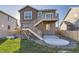 Exterior view of the home showcasing the backyard featuring the private deck and a vibrant green lawn at 926 W Beverly St, Elizabeth, CO 80107