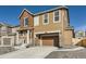 Two-story home featuring a two-car garage and covered porch with stone accents at 926 W Beverly St, Elizabeth, CO 80107