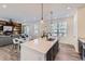 Open concept living area with island kitchen and wood accent wall in the living room at 926 W Beverly St, Elizabeth, CO 80107