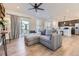 Bright, open living space with gray sectional, wood floors, and patio access to the backyard at 926 W Beverly St, Elizabeth, CO 80107