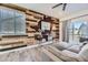 Comfortable living room with wood accent wall, stylish console table, and inviting gray sofa at 926 W Beverly St, Elizabeth, CO 80107