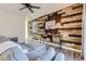 Cozy living room featuring a wood accent wall and stylish gray sectional sofa at 926 W Beverly St, Elizabeth, CO 80107