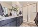 Modern bathroom with dual sinks, gray vanity, and glass-enclosed shower at 926 W Beverly St, Elizabeth, CO 80107