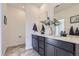 Bathroom featuring dual sinks, gray vanity, and modern finishes at 926 W Beverly St, Elizabeth, CO 80107