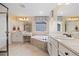 Bright bathroom with a soaking tub, dual vanity, and a shower behind a glass door at 17452 W 83Rd Pl, Arvada, CO 80007