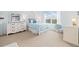 Bright bedroom with a bed, a dresser, and a large window at 17452 W 83Rd Pl, Arvada, CO 80007