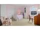 Bright pink bedroom with a bed, an armchair, and a dresser at 17452 W 83Rd Pl, Arvada, CO 80007