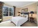 Cozy bedroom with neutral walls, carpet floors, and a large window providing plenty of natural light at 17452 W 83Rd Pl, Arvada, CO 80007