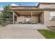 Covered back patio featuring plush outdoor seating with views of the green lawn at 17452 W 83Rd Pl, Arvada, CO 80007