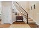 Elegant foyer with curved staircase, hardwood floors, and stylish decor at 17452 W 83Rd Pl, Arvada, CO 80007