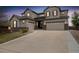Stunning two-story home with stone accents and three-car garage on a well-manicured lawn at 17452 W 83Rd Pl, Arvada, CO 80007