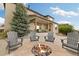 Backyard fire pit with Adirondack chairs and covered patio, perfect for outdoor gatherings at 17452 W 83Rd Pl, Arvada, CO 80007