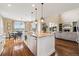 Open kitchen with a large island, granite countertops, stainless steel appliances, and an adjacent dining and living area at 17452 W 83Rd Pl, Arvada, CO 80007