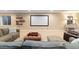 Spacious living room with a large screen, comfortable seating, and ample natural light at 17452 W 83Rd Pl, Arvada, CO 80007