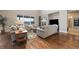 Spacious living room featuring hardwood floors, a fireplace, and ample natural light at 17452 W 83Rd Pl, Arvada, CO 80007