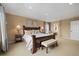 Spacious bedroom with a beautiful bed frame, bench, and two side tables with lamps at 17452 W 83Rd Pl, Arvada, CO 80007